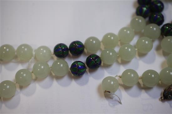A celadon jade and two colour enamel bead necklace with carved jade pendant, 32in.